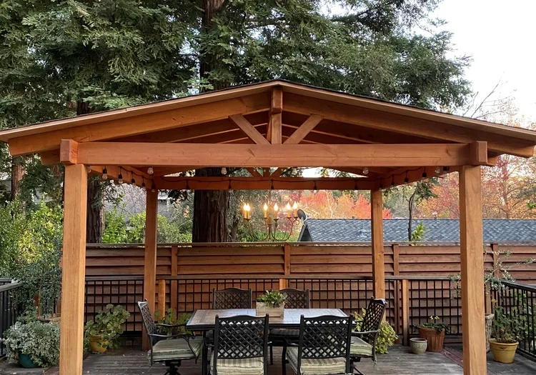 a-chandelier-hangs-under-a-backyard-pergola-desig-2024-09-15-05-44-43-utc